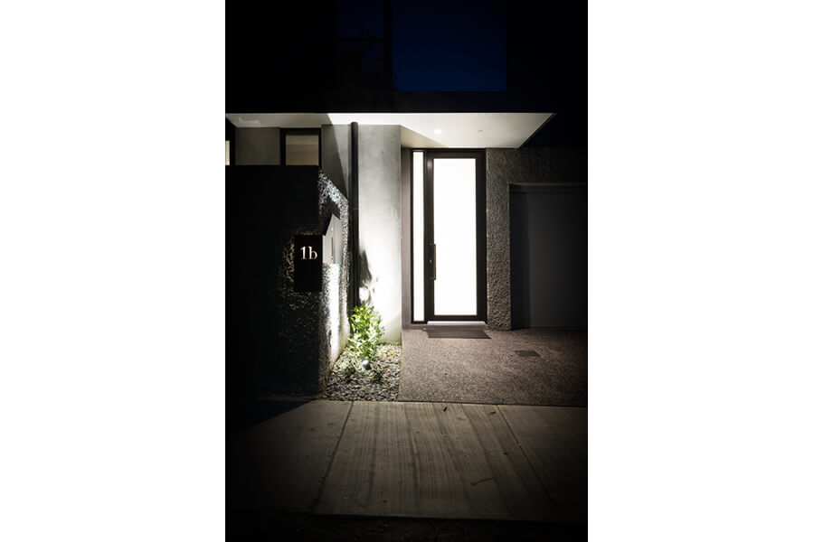 Two-Townhouses---Illuminated-front-entryway-featuring-Aluminium-entry-door